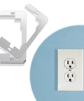 Galvanized Metal Outlet Spacers 2 Pack Flush Fit Device Leveling Plates beside a white electrical outlet on blue wall.