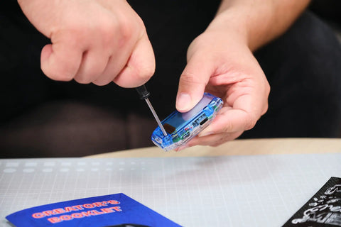 Clockstar 2.0 DIY Smartwatch Kit Build and Code Your Own Wearable Tech Learn Real Electronics and Coding in a Hands On STEM Gift for 11 Plus Kids and Teens, transparent watch being assembled with screwdriver