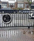 Iron gate with Beefy Cast Iron V Groove Caster Wheels 4 Inch Diameter One And One Half Inch Wide With Straight Roller Bearings
