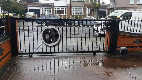 Iron gate with Beefy Cast Iron V Groove Caster Wheels 4 Inch Diameter One And One Half Inch Wide With Straight Roller Bearings