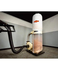 Professional Grade Heavy Duty Two HP Dust Collector Heavy Hitting Beast With Massive Twelve Inch Impeller Pumping One Thousand Five Hundred CFM Straight To Your Shop In White overview with impeller and dust bag.