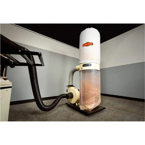 Professional Grade Heavy Duty Two HP Dust Collector Heavy Hitting Beast With Massive Twelve Inch Impeller Pumping One Thousand Five Hundred CFM Straight To Your Shop In White overview with impeller and dust bag.