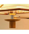 Close-up of the Slick Modern Swing Arm Wall Lamp with adjustable neck and fabric shade, showcasing the wooden mount and metallic details.