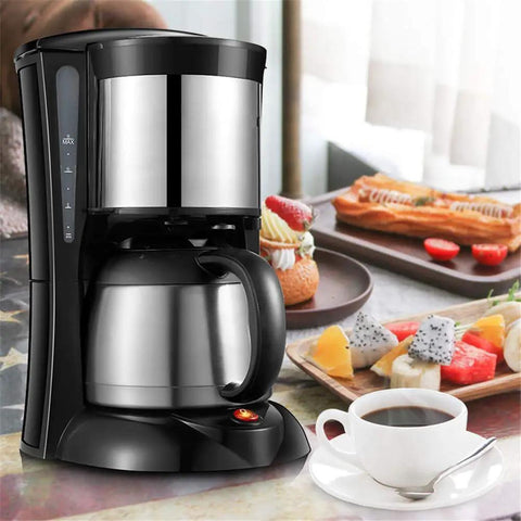Automatic Bean To Cup Coffee Maker Slick Stainless Steel Body with black base and coffee cup on a table with pastries.