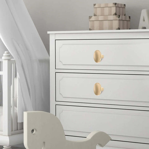 Gold Zinc Alloy Cabinet Pull Handle on white dresser drawers in nursery room
