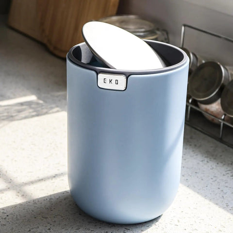 Ultra Compact 1.5L Mini Tabletop Trash Can With Swing Lid For Bathroom Vanity Or Desk Space Saving 4.7 Inch Diameter 6.5 Inch Tall Small Garbage Bin For Office Countertop in blue on counter