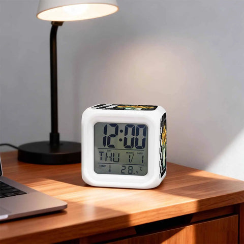 Solid Build Cube Digital Alarm Clock With Seven Color Led Night Light And Easy Peasy Snooze displayed on desk with lamp.