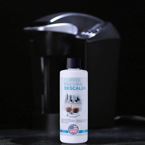 Pro Grade Descaler For Coffee And Espresso Makers 2 Bottle Pack 4 Uses with a single coffee machine in the background