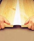 Hands pulling apart wood joined by Big Stretch Acrylic Latex Caulking Sealant High Performance Flexible Waterproof Sealant For Home Reno Projects 10.5 Oz Cartridge Clear Permanently Seals Gaps And Resists Cracking And Weather, showing flexibility and durability.