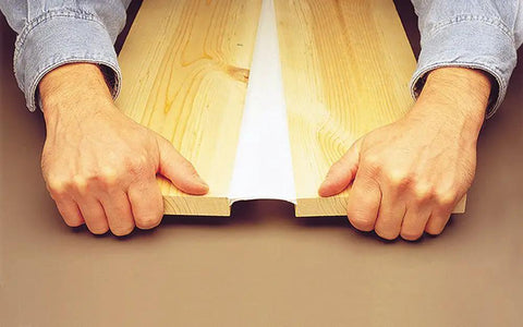 Hands pulling apart wood joined by Big Stretch Acrylic Latex Caulking Sealant High Performance Flexible Waterproof Sealant For Home Reno Projects 10.5 Oz Cartridge Clear Permanently Seals Gaps And Resists Cracking And Weather, showing flexibility and durability.