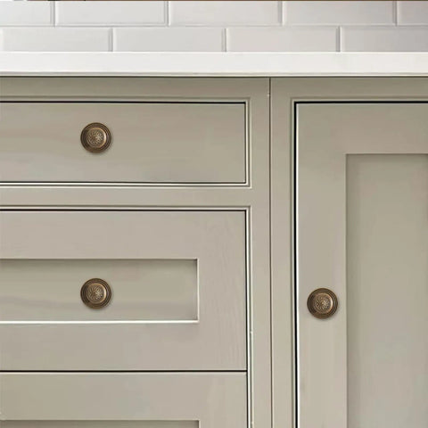 Old School Antique Brass Cabinet Knobs With Backplates 2.5 Inch 10 Pack Vintage Drawer Knobs For Cabinets Closets Dressers And Bi Fold Doors Durable Zinc Alloy Hardware shown on white drawers and cabinet doors.