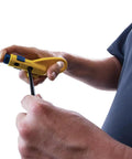 Man using Data And Coax Cable Stripping Tool With Radial Design For RG59 RG6 And CAT3 To CAT6A, focusing on adjustable blades.