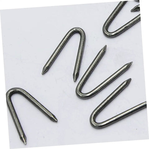 Close-up of U Shaped Garden Stakes And Fixing Nails Set For Fences And Ground Anchors Pro Grade 100 Piece U Nails For Easy Garden Projects.