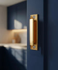 Two Piece Aluminum Alloy Drawer Pull Handles 3.5 Inch Low Profile Sash Lift Finger Pulls For Kitchen Cabinets And Dressers, Rust Proof Gold Finish With Screws Included, Durable Hardware installed on a cabinet door.