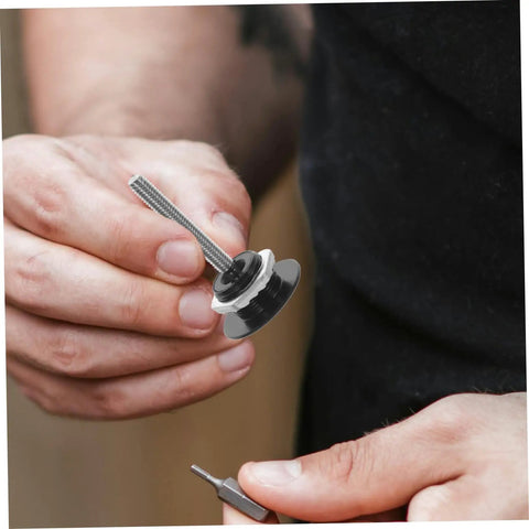 Close-up of hand holding Dope Push Button Hood Pin Latch Kit For Cars accessory, with black latch and threaded rod visible.