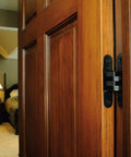 Hidden Concealed Door Hinge For Wood Or Metal Doors Mortise Mount Fits Doors 1.125 To 1.375 Inch Thick Zinc Invisible Hinge With Holes Black E Coat Exterior Finish SOSS 212US19 installed on wooden door indoors.
