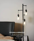 Black Floor Lamp With Three Glass Shade Branches Dope Industrial Tree Lamp For Living Room Or Office 64 Inch Tall Modern Farmhouse Style Includes Three 8W LED Edison Bulbs next to a bed.