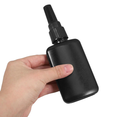 Get These Epic Glue Dispensing Bottles With Precision Nozzle Caps In Sleek Black, Perfect For Diy Crafts, Industrial Fixes, And Travel, hand holding a black HDPE plastic glue bottle.