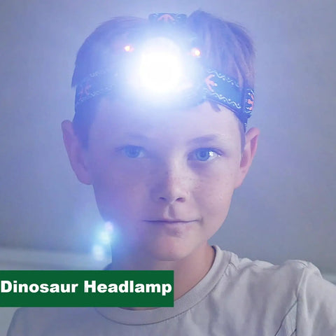 Child wearing Totally Rad LED Dinosaur Headlamp For Kids With Roar Sound And 3 Lighting Modes T Rex Shape flashing light
