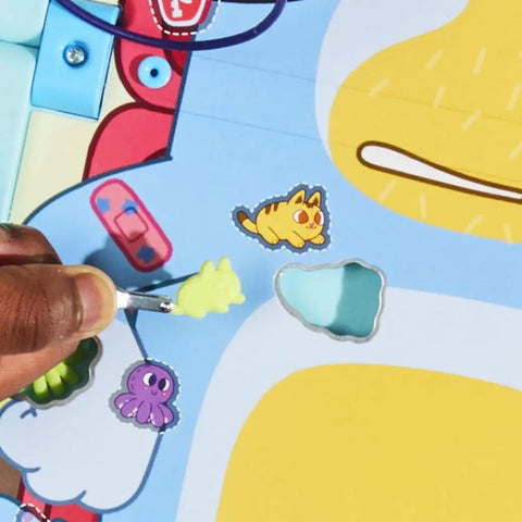 Player using a brush on stickers in the Legit Awesome Bluey Pediatrician Board Game For Kids Featuring Electronic Talking Sound Effects.