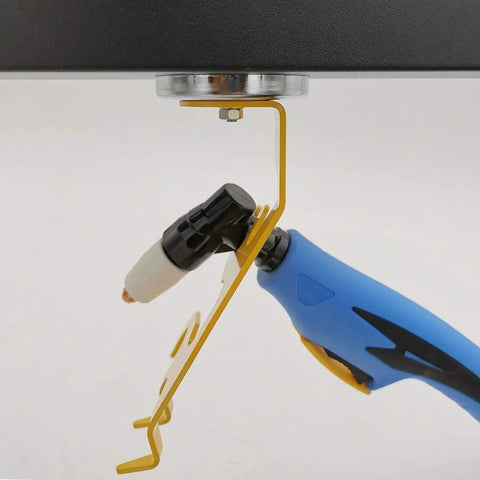 Side view of magnetic TIG torch holder with yellow bracket holding blue welding torch.