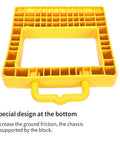 Close-up of yellow pallet jack wheel block showing special design at the bottom for increased friction. Professional Grade Solid As A Rock Heavy Duty Pallet Jack Stopper And Truck Chock Two Pack Yellow Trailer Wheel Block Antislip Base No Sweat Moving Logistics Gear For Warehouses.