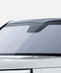 Custom Fit Rivian R2 Front Sunshade Keeps Your Whip Cool And Blocks Harsh UV Rays With Easy Fold Design And Sleek Matte Silver Finish mounted on windshield.