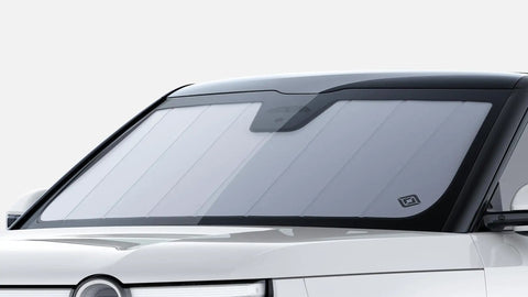 Custom Fit Rivian R2 Front Sunshade Keeps Your Whip Cool And Blocks Harsh UV Rays With Easy Fold Design And Sleek Matte Silver Finish mounted on windshield.