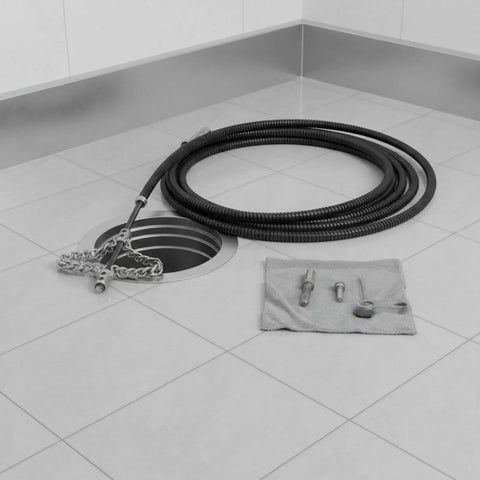 Heavy Duty Flexible Chain Knocker Drain Snake Auger With Solid Steel Core, 16mm shaft beside a floor drain and tools.