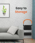 2 Step Folding Step Stool Ladder With 330Lb Heavy Duty Steel Frame next to a grey sofa and cactus picture in a living room
