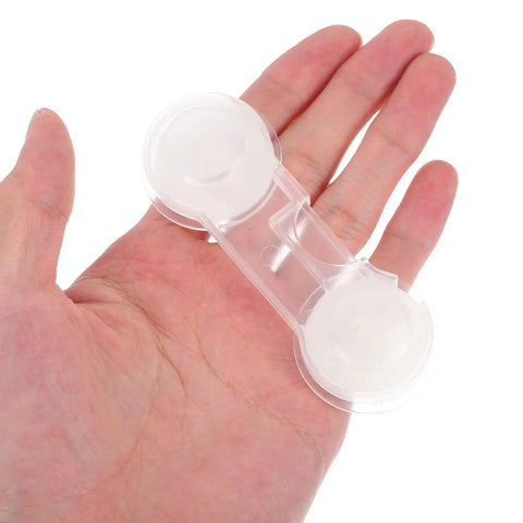 Transparent ABS lock from Kid Proof Cabinet And Fridge Safety Locks Set 10 Pieces held in hand for size reference.