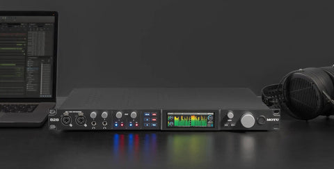 Next Gen 28x32 USB3 Audio Interface with 24-bit RGB Display and real-time metering on studio desk with headphones and laptop