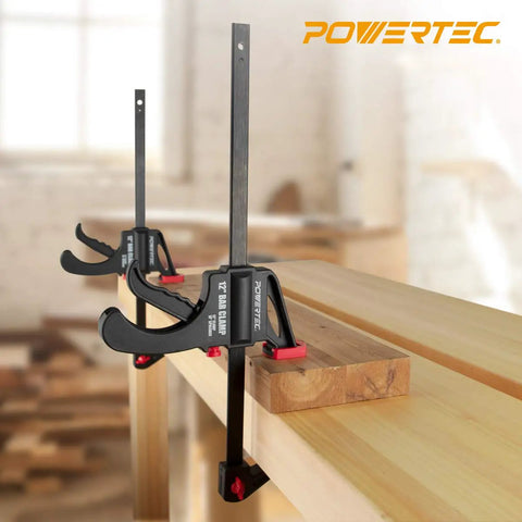 24 Inch Quick Release Bar Clamp With 30 Inch Spreader, Ratcheting Design, shown clamping wood in a workshop setting