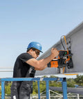 Heavy Duty Magnetic Base Drill Built Tough For One Quarter Inch Steel Cuts used by a worker on a steel beam at a construction site.