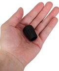 Four Pack Black TPR Rubber Feet For Camping Chairs And Folding Seats, Anti Sink Ground Protection With Textured Bottom shown in hand