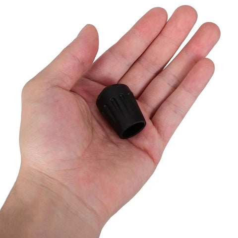 Four Pack Black TPR Rubber Feet For Camping Chairs And Folding Seats, Anti Sink Ground Protection With Textured Bottom shown in hand