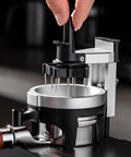 Premium 58 Millimeter Espresso Puck Distributor With Adjustable Height Rotary Pointer in use for coffee ground leveling.