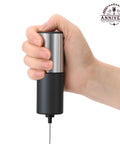 Handheld Electric Milk Frother And Drink Mixer Creates Rich Creamy Foam In Seconds With Stainless Steel Whisk held in hand.