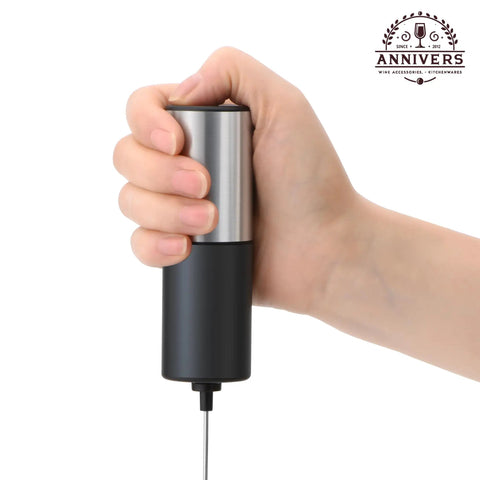 Handheld Electric Milk Frother And Drink Mixer Creates Rich Creamy Foam In Seconds With Stainless Steel Whisk held in hand.