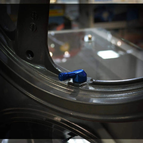 Installed Angled Valve Stem Set With Pre Applied Threadlocker Nut Forged Aluminum Construction 0.357 Inch (8.3mm) Size Blue Finish