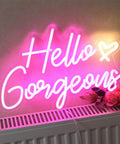 Pink LED Neon Sign Hello Gorgeous For Home Decor And Party Backdrops glowing on wall, 16.5x10.6 inches, USB powered