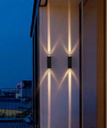 Modern Led Outdoor Wall Sconce, 2-Pack 20w Updown Wall Wash Light, Black Metal Ip65 illuminating an outdoor wall at night.