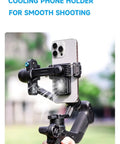 Scorp Mini 3 Gimbal Stabilizer for Smartphones with iPhone mounted, showing built-in cooling fan and integrated grip in outdoor use.