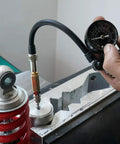 NICECNC nitrogen needle kit with gauge attached to a shock absorber; red coil spring visible