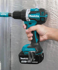 Top Shelf Compact 18V LXT Brushless Cordless Driver Drill Kit With 5Ah Lithium Battery, being held against metal surface.