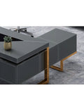 Solid As A Rock L Shaped Desk With Blue And Gold Finishes Heavy Duty Executive Computer Table Workhorse For Modern Home Office Setup Featuring Deep Drawer And Level Base close-up of gray desk with gold accents and succulent.