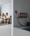 Heavy Duty 2500W Sump Pump Battery Backup Inverter With LCD Display And Pure Sine Wave connected to battery in living room.