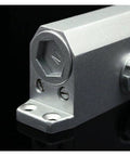 Close-up of metal part of Hydraulic Door Closer With Adjustable Speed For Doors Between 15Kg And 45Kg No Slam Quiet Soft Close Built