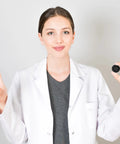 Young woman in a lab coat showing a black latex finger cot, promoting Ace Every Shift With This 400 Pack Black Latex Finger Cots Kit.