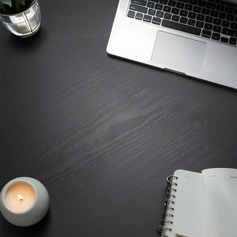 Dope Matte Black Peel And Stick Wood Texture Wallpaper Roll 16 Inch By 120 Inch Self Adhesive Cover on desk surface with laptop and candle
